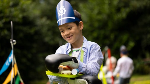 A boy enjoying the summer of play activities at Mottisfont, Hampshire